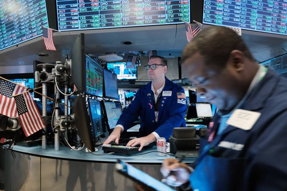 Traders work on the floor of the New York Stock Exchange on October 27, 2022. — AFP pic