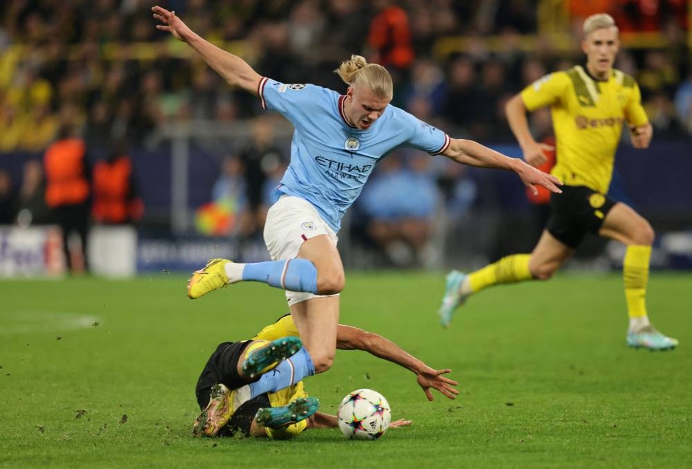 Manchester City’s Erling Haaland in action with Borussia Dortmund’s Emre Can at Signal Iduna Park, Dortmund, Germany, October 25, 2022. — Reuters pic 