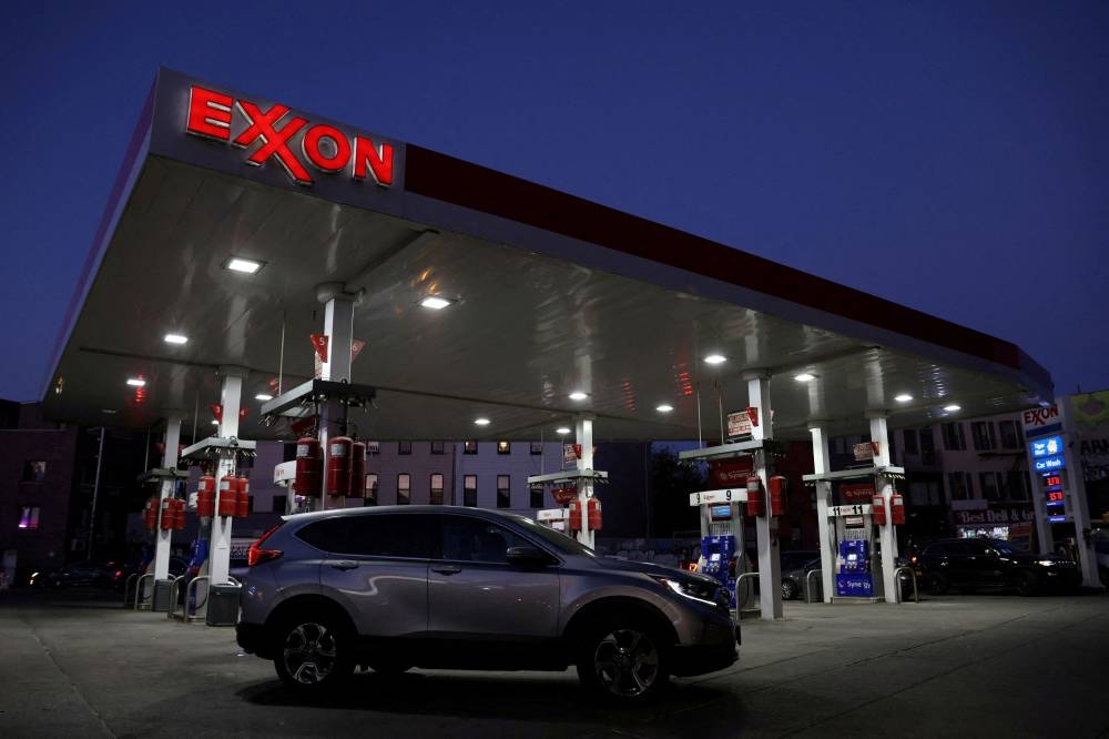 Cars are seen at an Exxon gas station in Brooklyn, New York City November 23, 2021. — Reuters pic