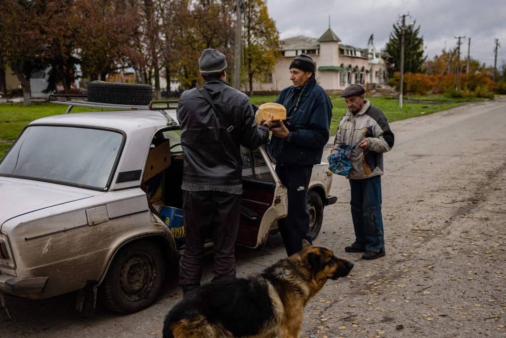 Local residents buy a bread in the village of Drobysheve in eastern Ukraine’s Donetsk region, on October 28, 2022, after the liberation of the area. — AFP pic