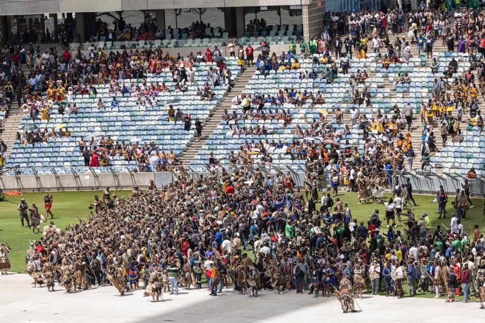 Amabutho, Zulu King regiments, clad in traditional dresses and carrying shields and sticks, enter the Moses Mabhida Stadium   in Durban on October 29, 2022, for the handover of the official certificate of recognition for the Zulu King Misuzulu. — AFP pic