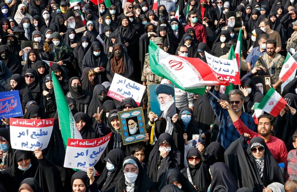 Iranians rally in the capital Tehran to denounce a mass shooting at a key shrine that killed more than a dozen worshippers, on October 28, 2022. — AFP pic
