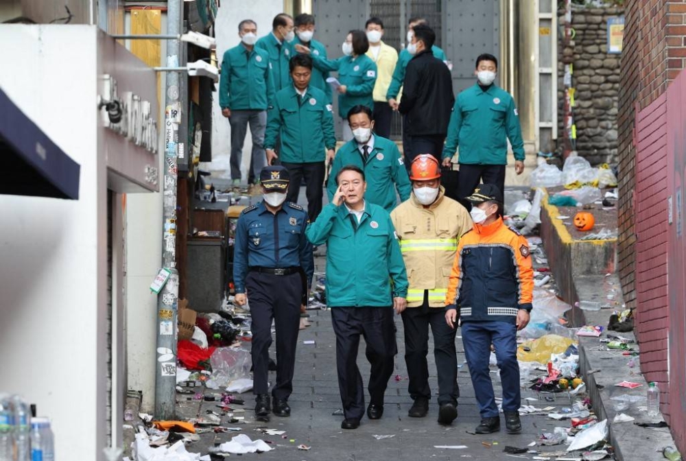 South Korea's South Korea's President Yoon Suk-yeol (front second left) visits the scene of a Halloween stampede in the capital's popular Itaewon district, in Seoul on October 30, 2022. At least 149 people were killed and scores more were injured in a stampede at a packed Halloween event in central Seoul late on October 29, officials said, in one of South Korea's worst peacetime accidents. — YONHAP / AFP pic