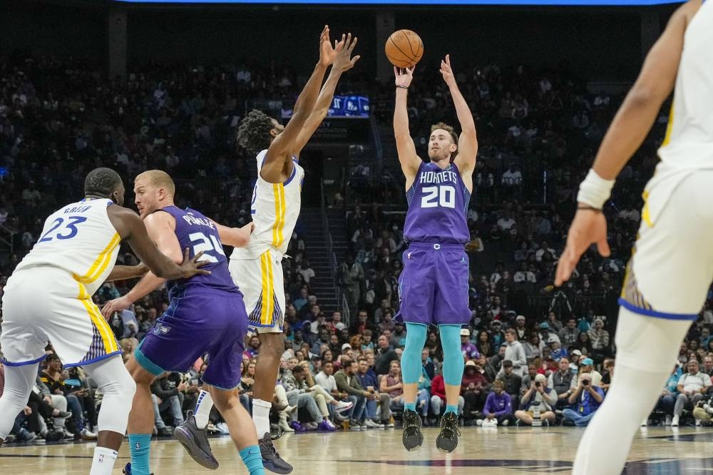 Charlotte Hornets forward Gordon Hayward (20) shoots over Golden State Warriors forward Andrew Wiggins (22) during the second half at Spectrum Center. — Jim Dedmon-USA TODAY Sports pic
