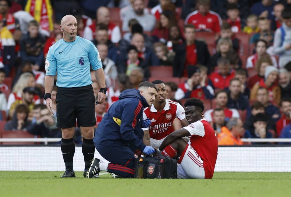 Arsenal's Bukayo Saka receives medical attention after sustaining an injury against Nottingham Forest at the Emirates Stadium, London October 30, 2022. — Reuters pic