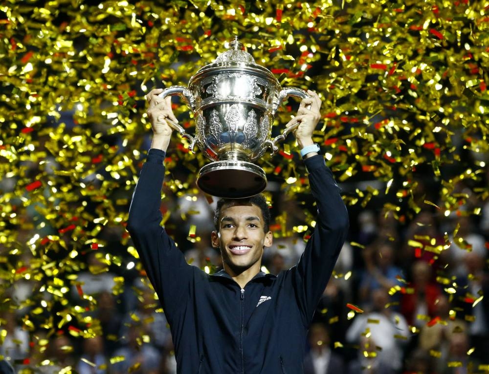 Canada's Felix Auger-Aliassime celebrates with trophy after winning his final match against Denmark's Holger Rune in Basel October 30, 2022. — Reuters pic