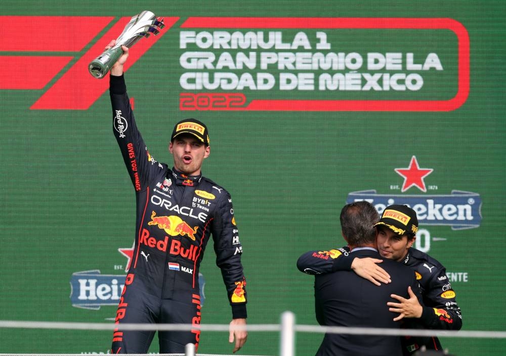 Red Bull's Max Verstappen celebrates on the podium with the trophy after winning the Mexico Grand Prix with third placed Red Bull's Sergio Perez October 30, 2022. — Reuters pic