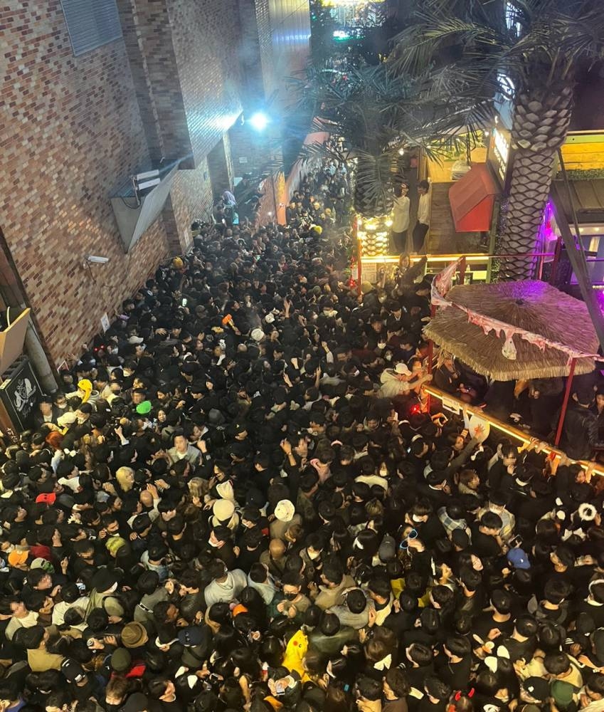 A street in Itaewon district is pictured full of people before a stampede during Halloween festivities killed and injured many in Seoul, South Korea, in this image released by Yonhap on October 30, 2022. — Yonhap via Reuters pic