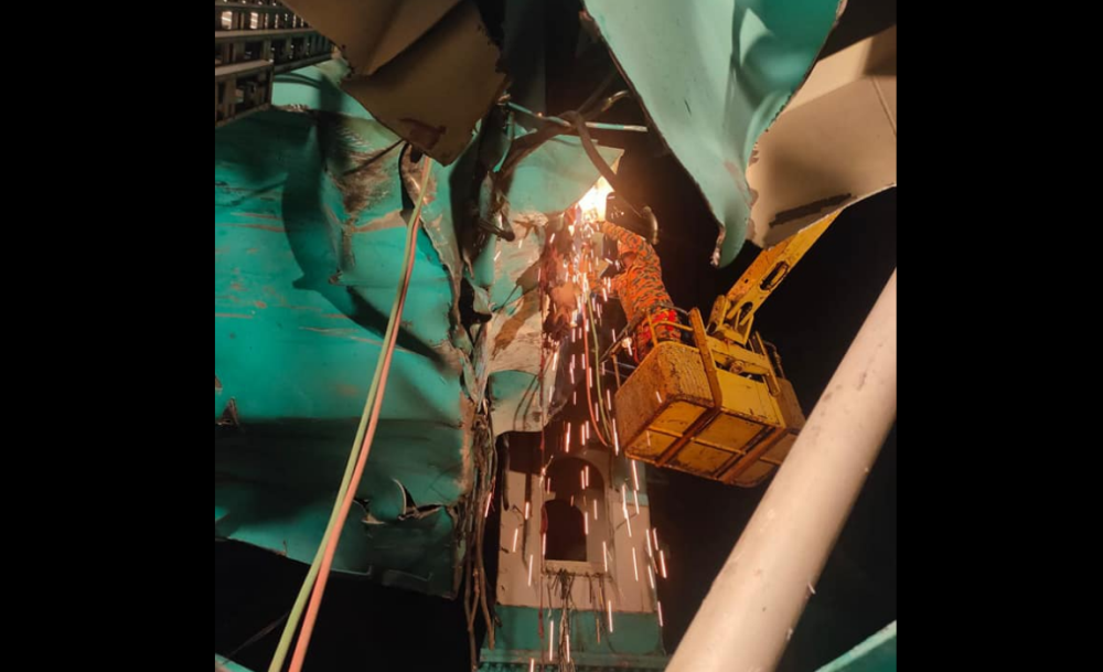 Perak Fire and Rescue Department attempt to extract victims after a crane collapsed at a factory in the Kampung Acheh industrial area in Sitiawan. — Picture via Facebook