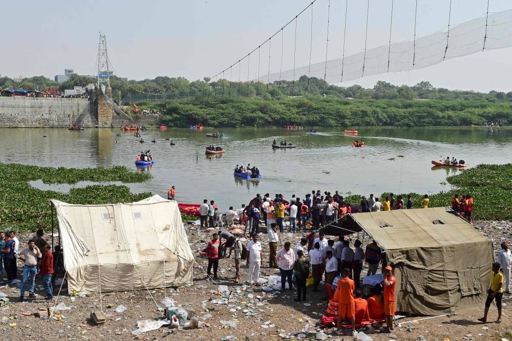 Rescue personnel conduct search operations after a bridge across the river Machchhu collapsed at Morbi in India's Gujarat state October 31, 2022. — AFP pic