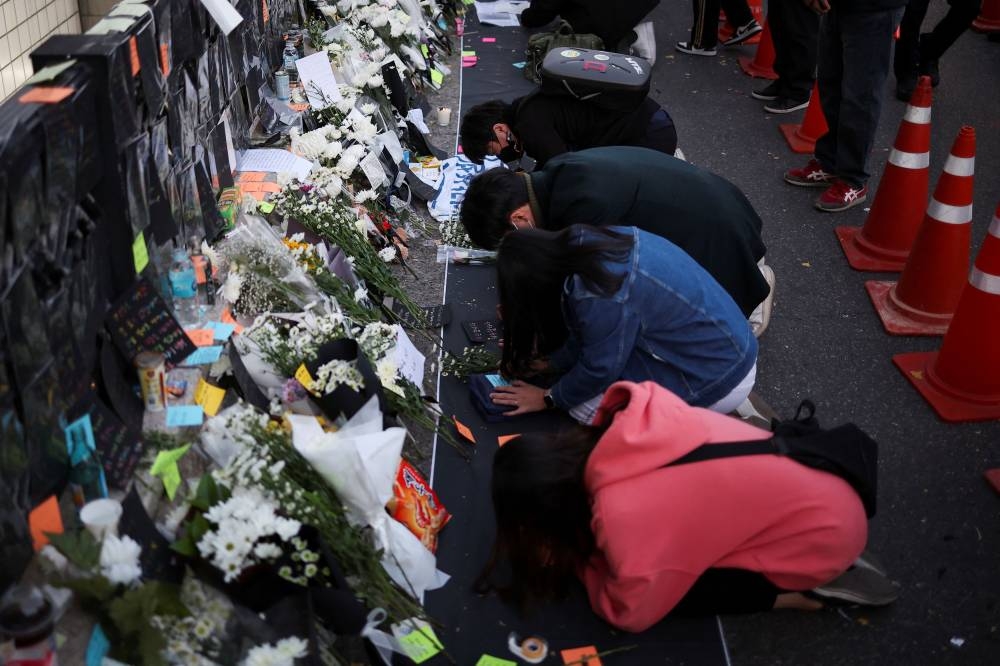 People pay their respects near the scene of a crowd crush that happened during Halloween festivities, in Seoul, South Korea, November 1, 2022. — Reuters pic