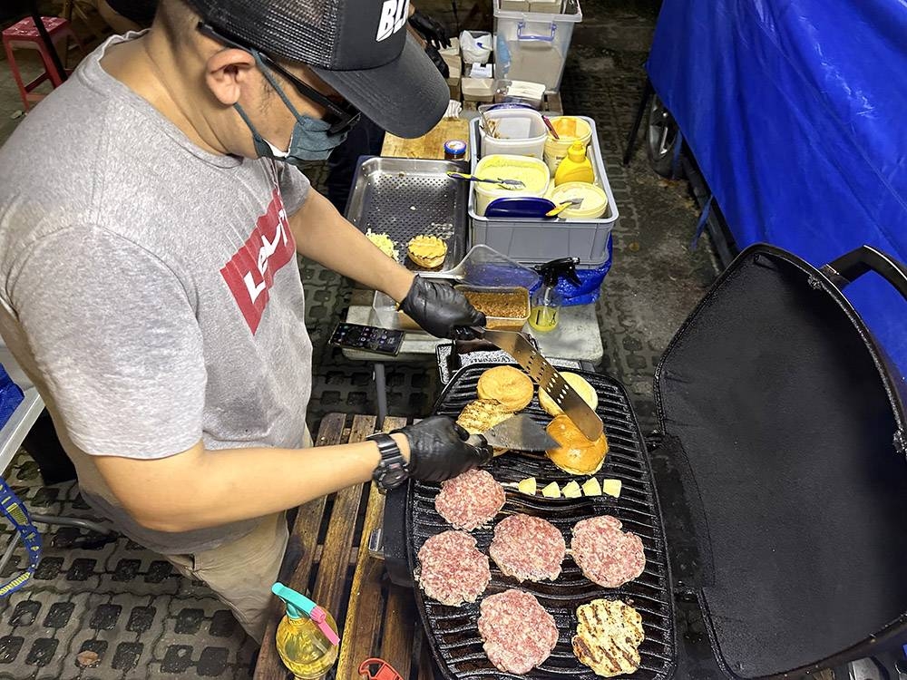 Grilling up the burger patties and buns are done in batches.