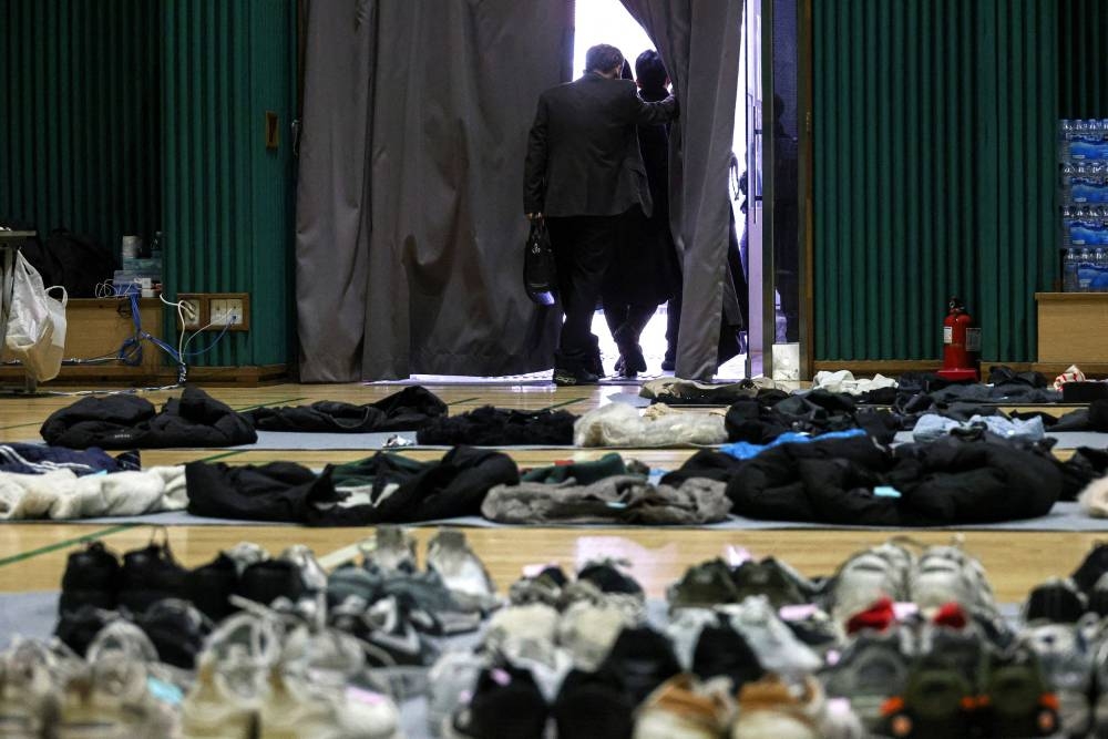 A family member of a victim leaves after collecting the belongings of the victim from the gym, where recovered belongings of the victims of a crowd crush that happened during Halloween festivities are kept, in Seoul, South Korea November 2, 2022. — Reuters pic