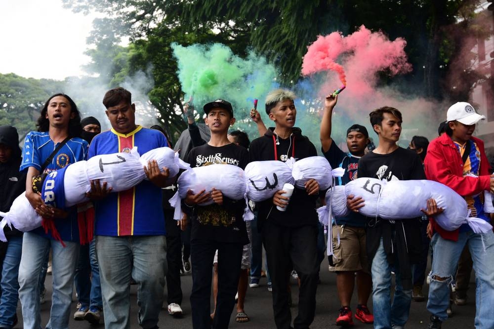 Football fans take part in a rally in front of the city hall in Malang on October 26, 2022, demanding PSSI (Indonesian football association) to responsible and fair, transparent and indiscriminate law enforcement following the deadly stampede at Kanjuruhan stadium on October 1 that killed 135 people. — AFP pic