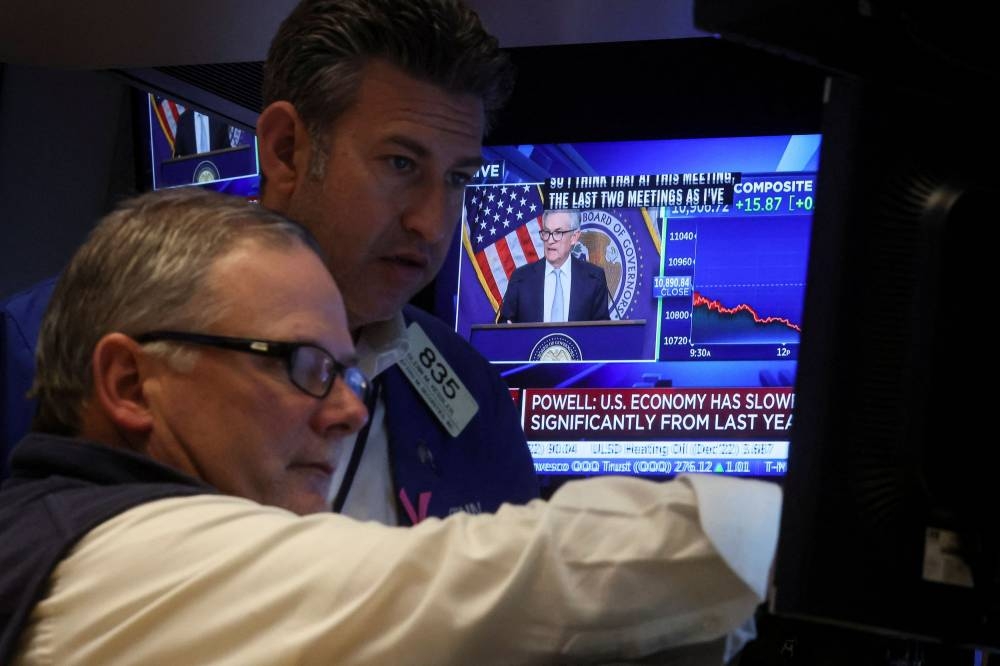 Traders react as Federal Reserve Chair Jerome Powell speaks on a screen on the floor of the New York Stock Exchange in New York City November 2, 2022. — Reuters pic