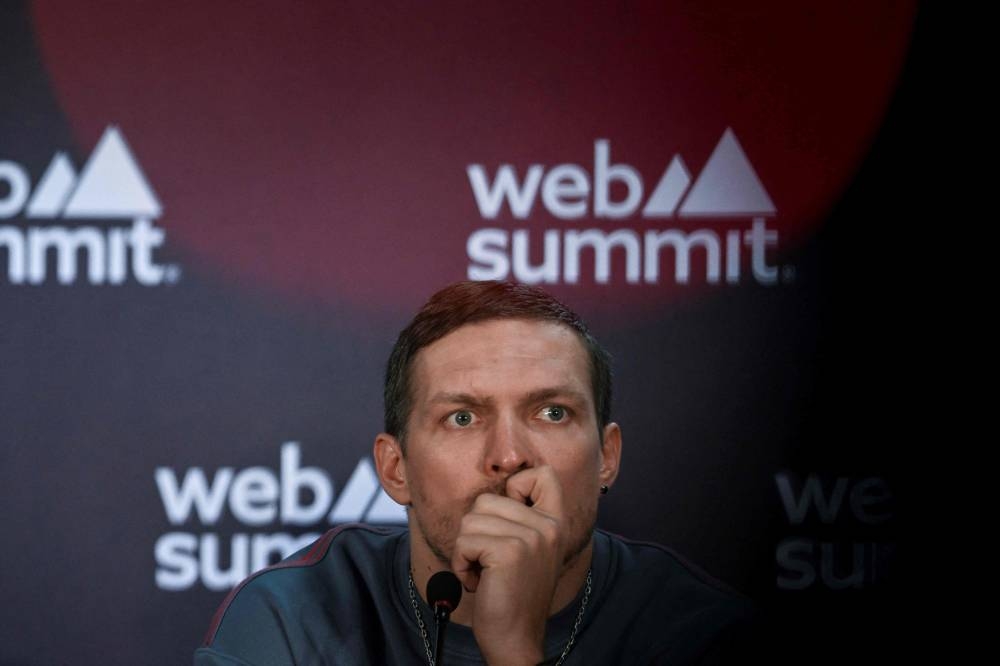Ukrainian world heavyweight boxing champion Oleksandr Usyk speaks during a press conference at the Europe's largest tech conference, the Web Summit, in Lisbon on November 2, 2022. — AFP pic