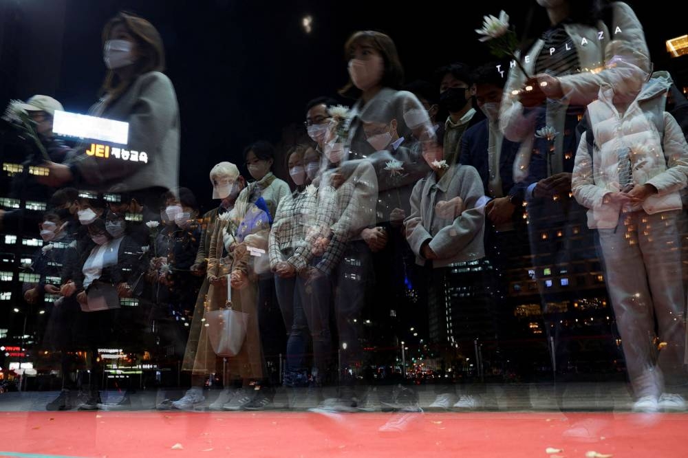 People mourn at a group memorial for the victims of the crowd crush that happened during Halloween festivities, at Seoul City Hall Plaza in Seoul, South Korea, November 3, 2022. — Reuters pic