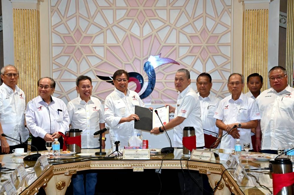 Sarawak Tan Sri Abang Johari Openg (4th left) hands the candidate document to Parti Pesaka Bumiputera Bersatu (PBB) senior vice president Datuk Seri Fadillah Yusof (centre) at the PBB headquarters in Kuching November 3, 2022. — Bernama pic