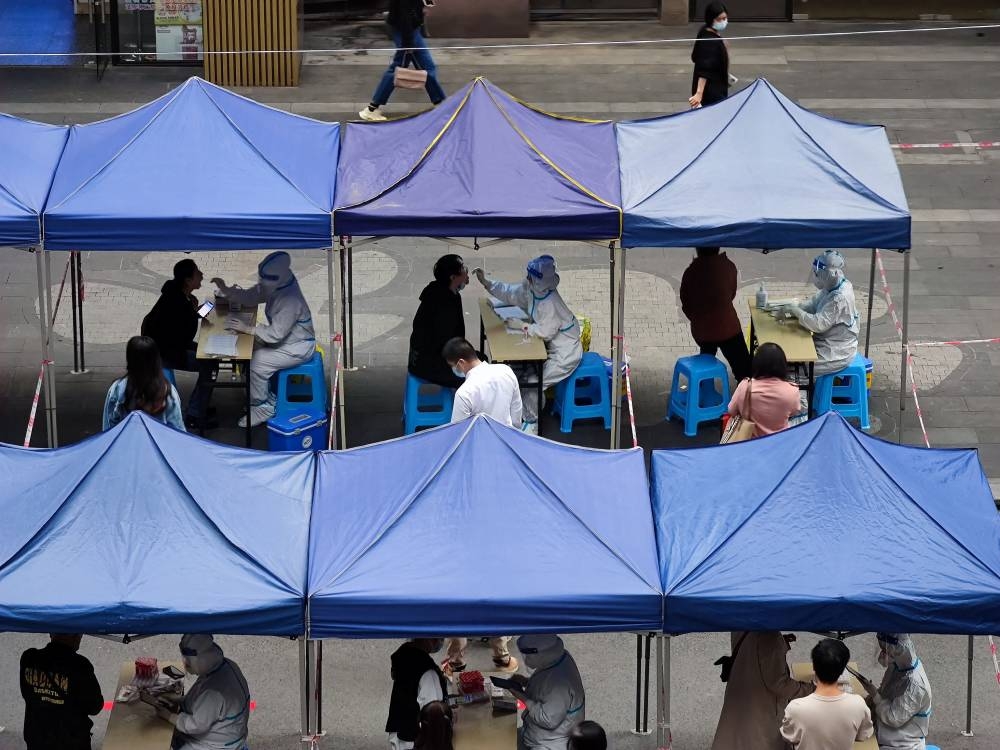 Medical workers take swap samples from residents for nucleic acid test for coronavirus disease (Covid-19), at a testing site in Chongqing November 3, 2022. — China Daily pic via Reuters