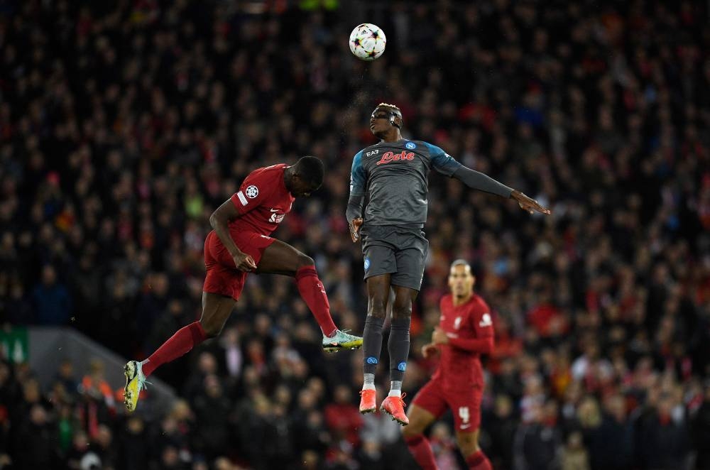 Liverpool’s French defender Ibrahima Konate (left) jumps up to head the ball with Napoli’s Nigerian striker Victor Osimhen during the Uefa Champions League group A match in Liverpool, north west England, November 1, 2022. — AFP pic 