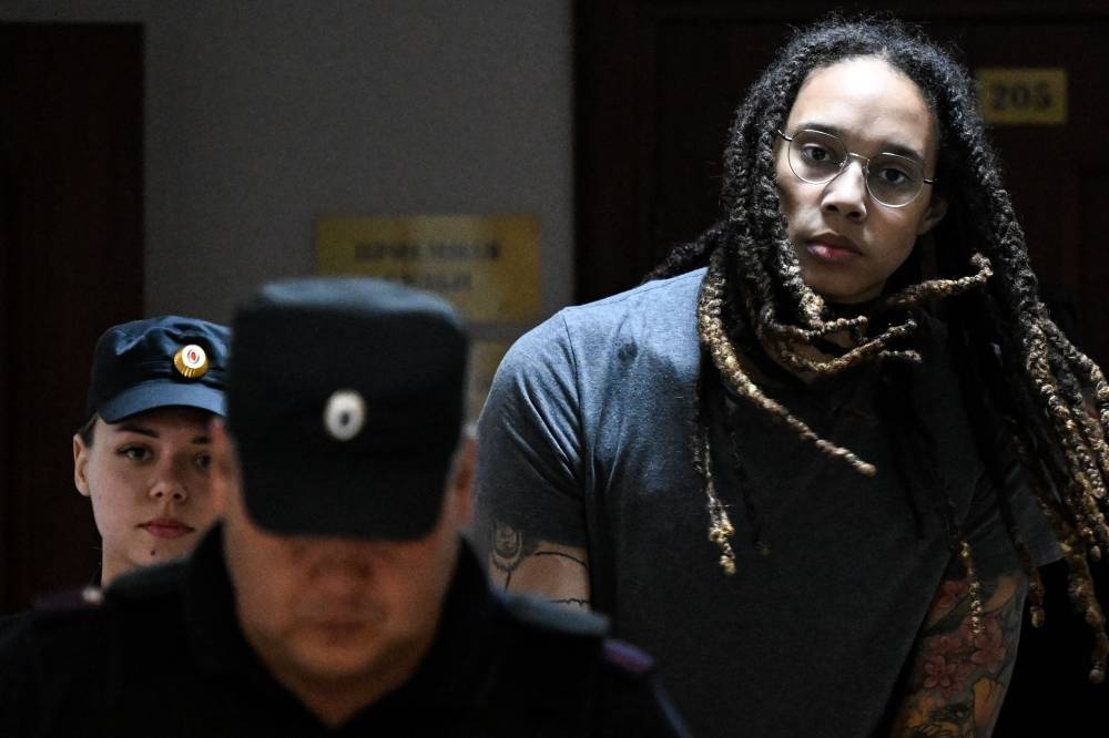US Women National Basketball Association's basketball player Brittney Griner is escorted to the courtroom to hear the court's final decision in Khimki outside Moscow August 4, 2022. — AFP pic