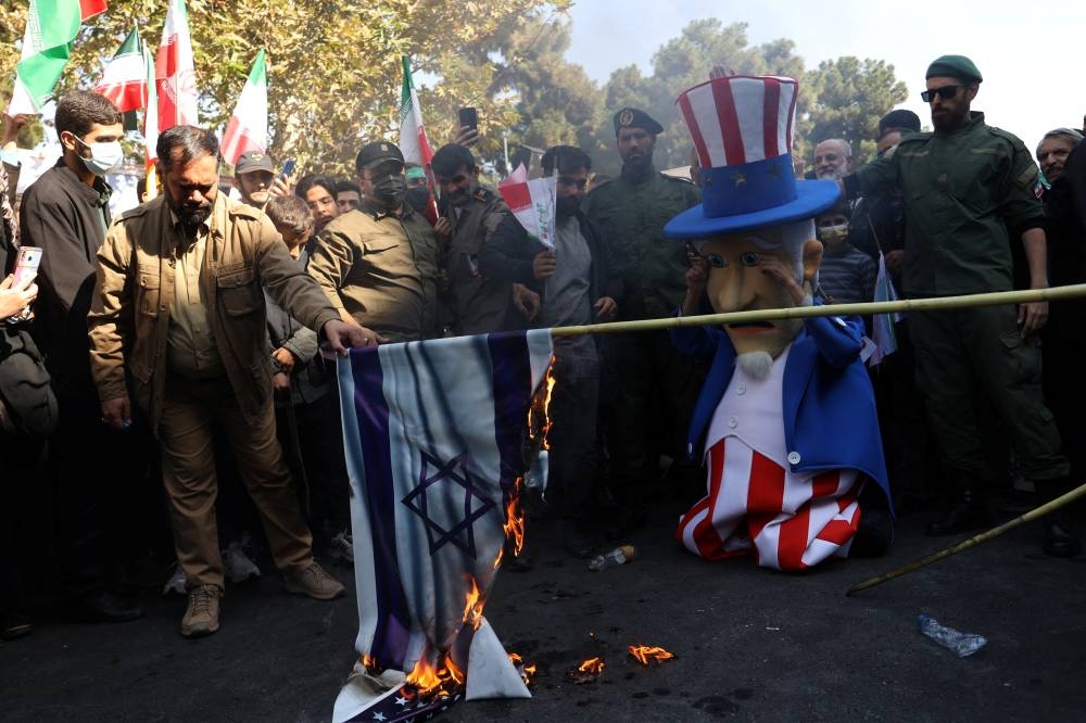 Iranians burn an Israeli and American flags during the 43rd anniversary of the U.S. expulsion from Iran, in Tehran, Iran November 4, 2022. — WANA (West Asia News Agency) via Reuters