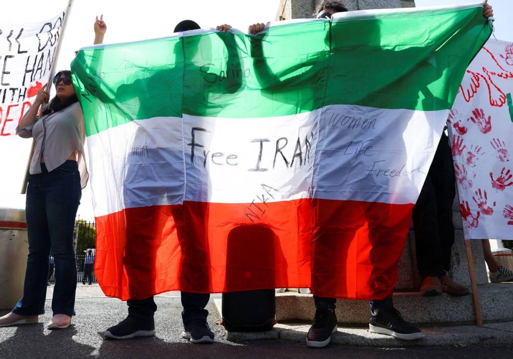 File photo of people holding up the Iranian flag in Cape Town. — file pic