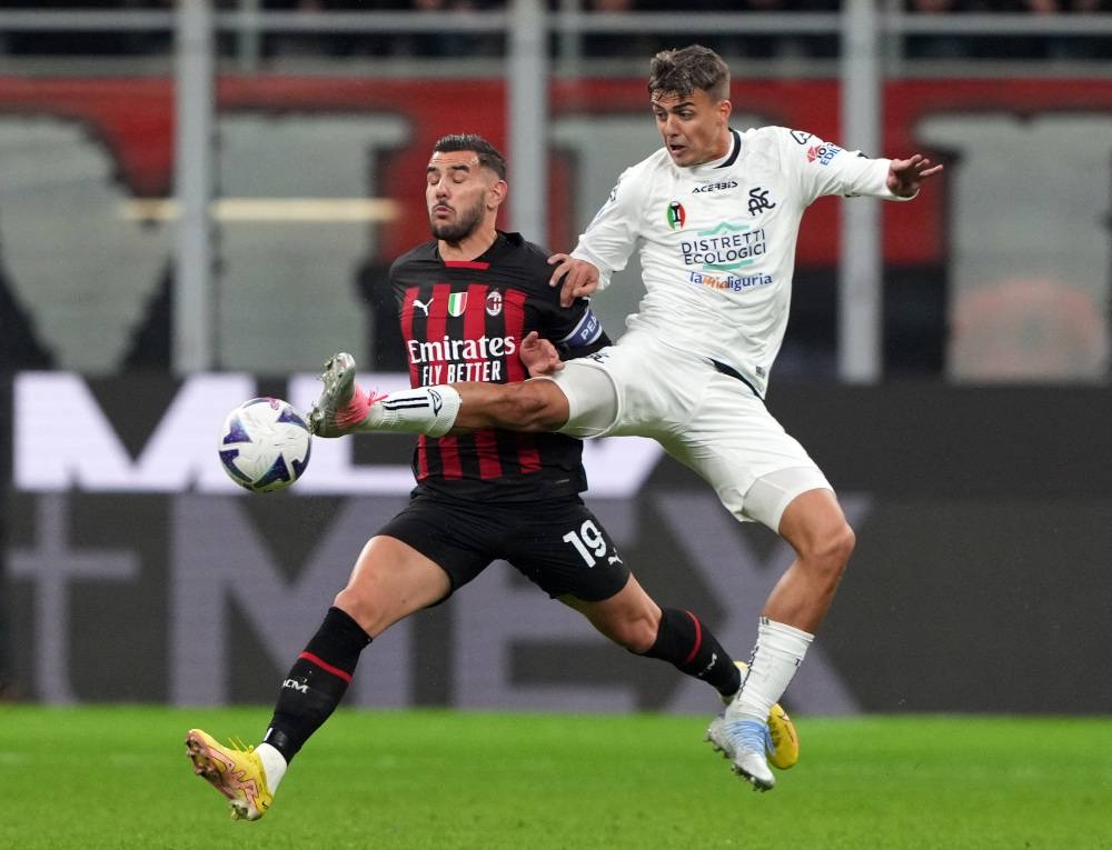 AC Milan’s Theo Hernandez in action with Spezia’s Daniel Maldini during the Serie A match at San Siro, Milan November 5, 2022. — Reuters pic