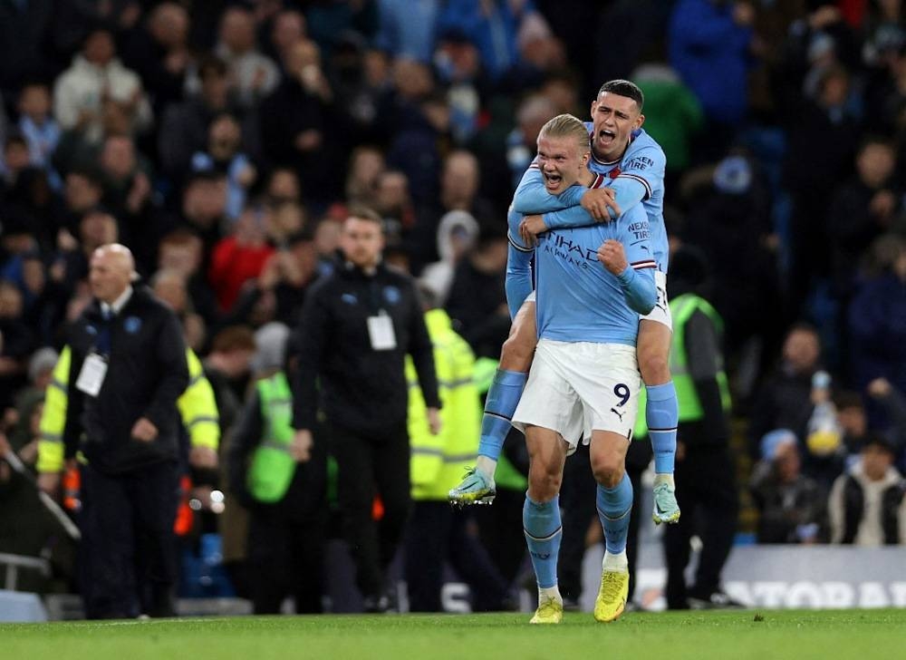 Manchester City’s Norwegian striker Erling Haaland (left) celebrates scoring the team’s second goal from the penalty spot during the English Premier League football match between Manchester City and Fulham at the Etihad Stadium in Manchester, north-west England, on November 5, 2022. — AFP pic