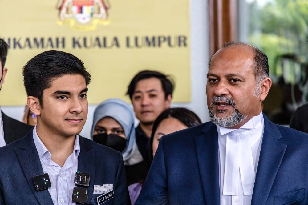 Gobind Singh Deo (right) speaks during a press conference after court decision on Syed Saddiq Abdul Rahman's (left) case at Kuala Lumpur High Court in Kuala Lumpur on October 28, 2022. — Picture by Firdaus Latif