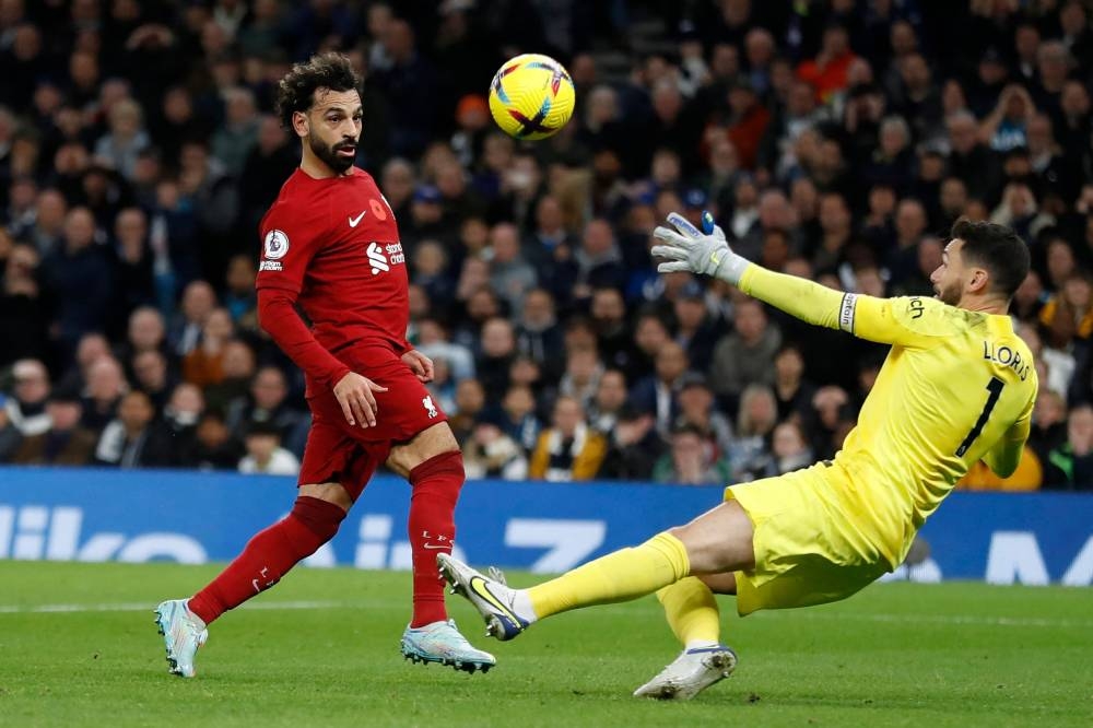 Liverpool's Egyptian striker Mohamed Salah (L) scores his team's second goal past Tottenham Hotspur's French goalkeeper Hugo Lloris (R) during the English Premier League football match between Tottenham Hotspur and Liverpool at Tottenham Hotspur Stadium in London, on November 6, 2022.  — AFP pic