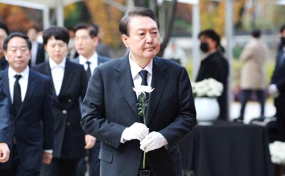 South Korean President Yoon Suk-yeol visits a memorial altar for victims of a stampede that happened during Halloween festivities in Seoul, South Korea in this photo released by Yonhap on November 3, 2022. — Yonhap via Reuters pic