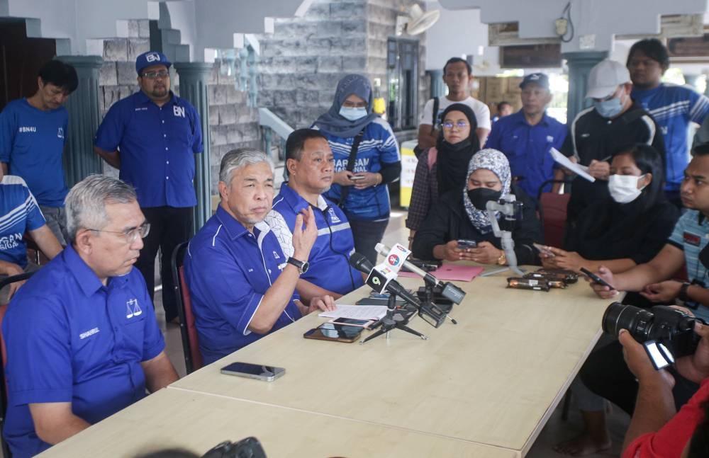 Barisan Nasional chairman Datuk Seri Ahmad Zahid Hamidi (seated, second left) speaks during a press conference at his house in Sungai Nipah Darat, Bagan Datuk November 7, 2022. — Picture By Farhan Najib