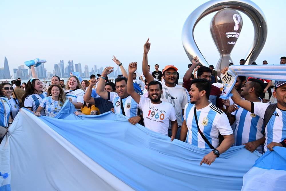 Argentina's fans cheer in front of the FifaWorld Cup countdown clock in Doha on November 7, 2022. — AFP pic