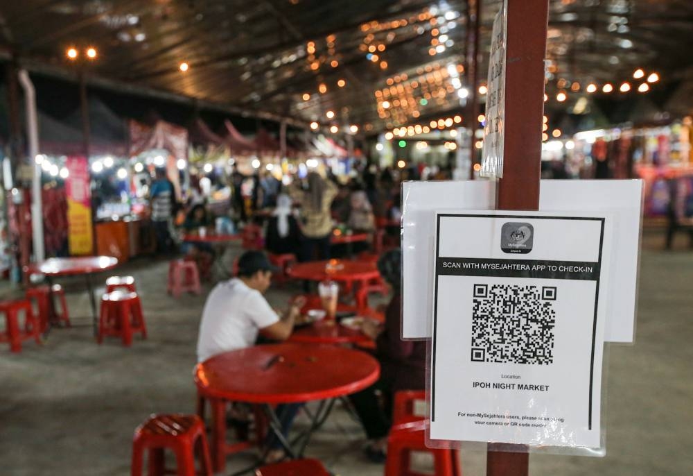 A MySejahtera scanning point is seen at the Ipoh Night Market in Ipoh March 9, 2022. — Picture by Farhan Najib