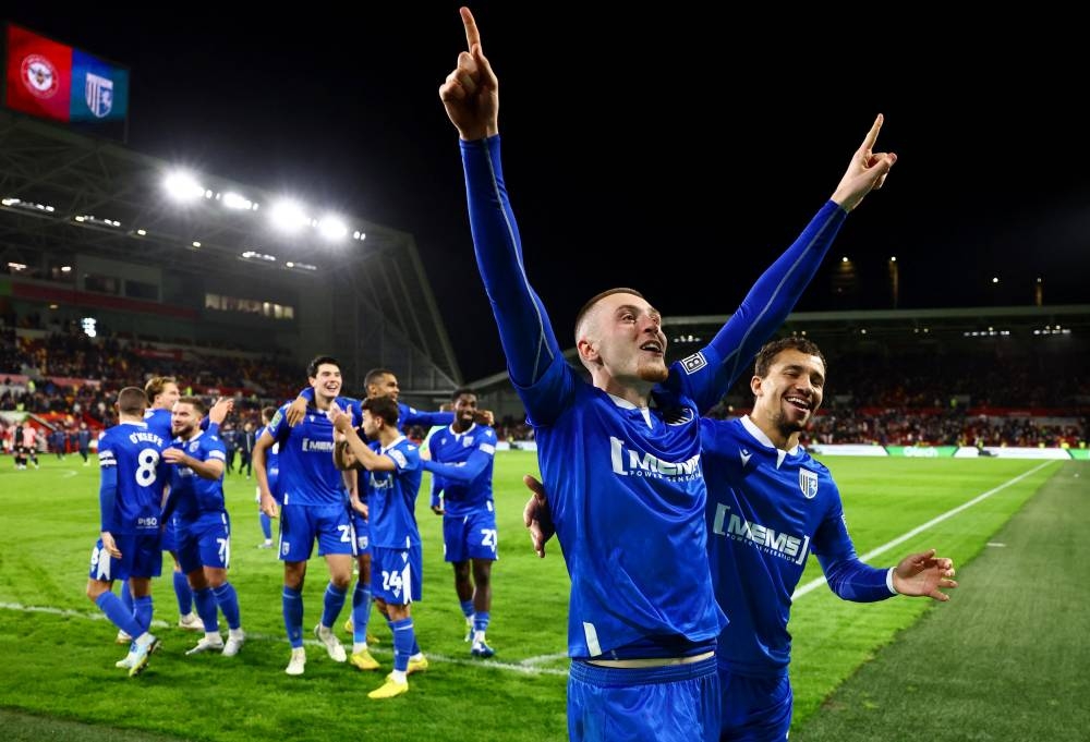 Gillingham's Cheye Alexander celebrates with Dom Jefferies after winning the penalty shootout against Brentford at the Brentford Community Stadium, London November 8, 2022. — Reuters pic 