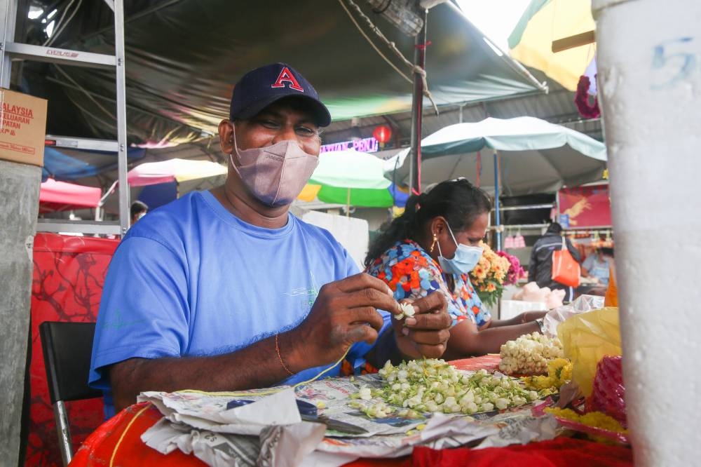 Flower garland seller V. Chandran speaks to Malay Mail at the Taman Muda wet market November 6, 2022. 