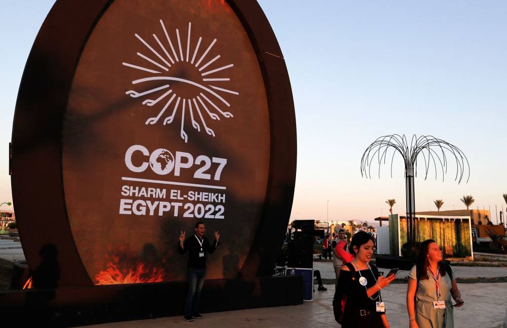 People walk at the green zone of the Sharm el-Sheikh International Convention Centre, during the COP27 climate conference in Egypt's Red Sea resort city of the same name, on November 9, 2022. — AFP pic