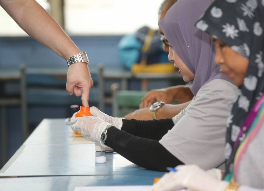 The subsection states that every employer shall, on polling day, allow to every elector in his employ a reasonable period for voting, and no employer shall make any deduction from the payor other remuneration of any such elector or impose upon or exact from him any penalty by reason of his absence during such period. — Picture by Marcus Pheong