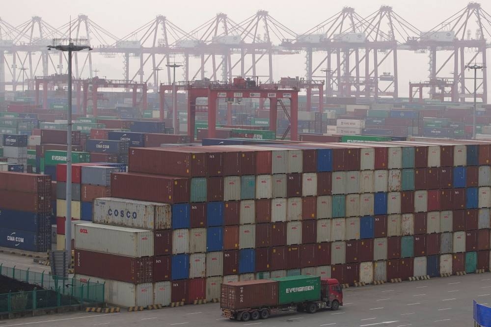 A truck drives past containers at the Yangshan Deep Water Port in Shanghai, China January 13, 2022. — Reuters pic