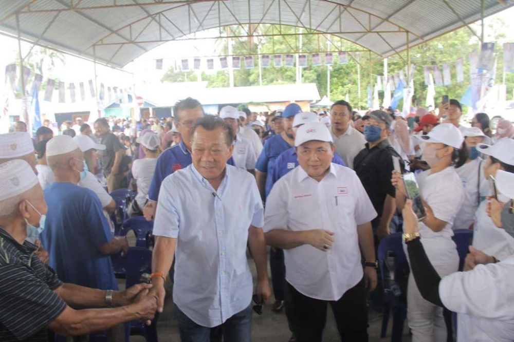 Bung accompanied by Matbali, Sipitang Umno leader Datuk Kamarlin Ombi and Lumadan assemblyman Datuk Ruslan Muhaharam arriving at the campaigning. — Borneo Post pic