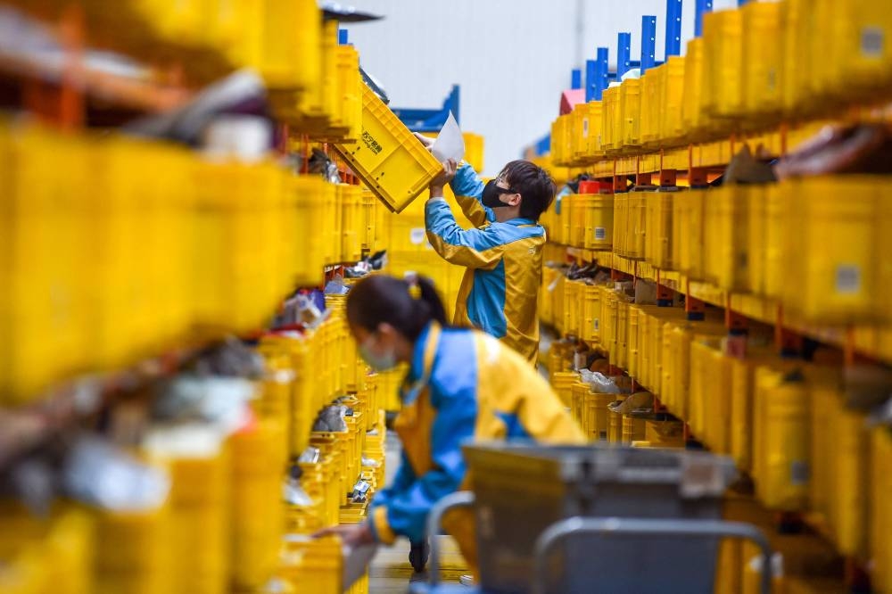 An employee prepares items for delivery ahead of the Singles’ Day shopping festival which falls on November 11, at a logistics center in Nanjing, in China's eastern Jiangsu province on November 10, 2022. — AFP pic