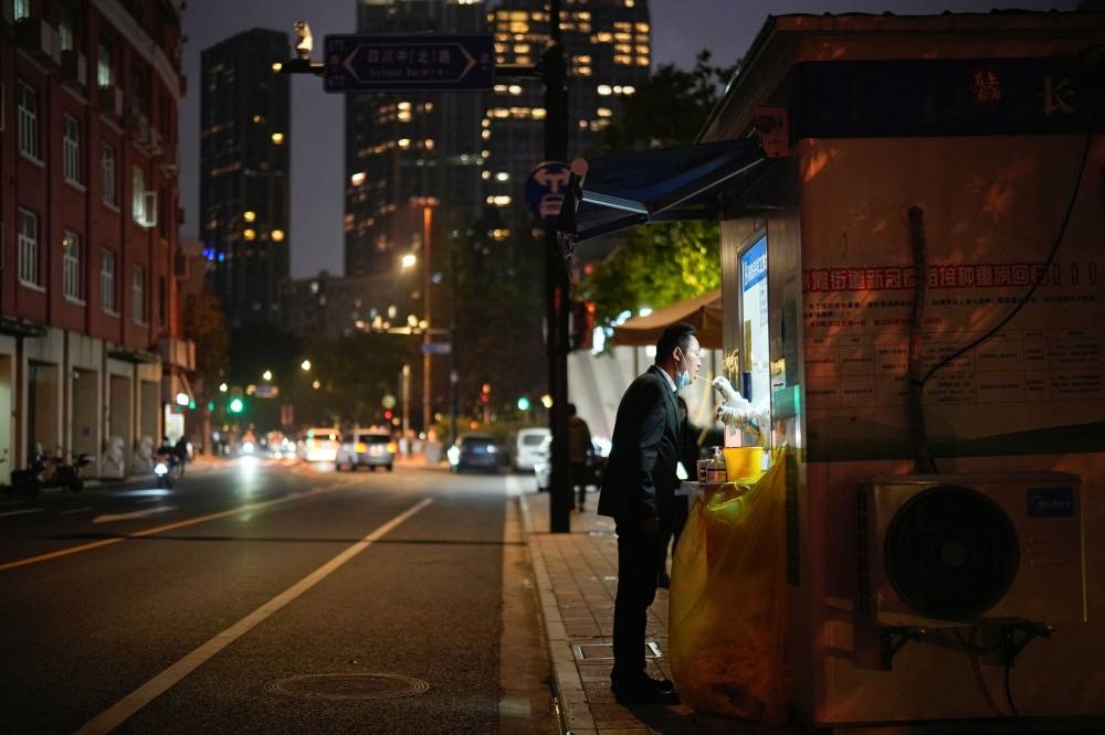 A man is tested for Covid-19 at a nucleic acid testing site, following a coronavirus disease (COVID-19) outbreak in Shanghai, China November 10, 2022. ― Reuters pic