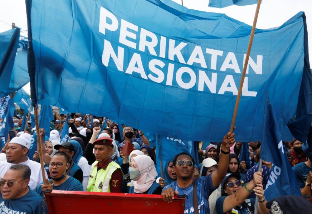 Perikatan Nasional supporters hold the party flags during nomination process for Malaysia’s general election in Tambun, Perak, Malaysia, November 5, 2022. — Reuters pic 