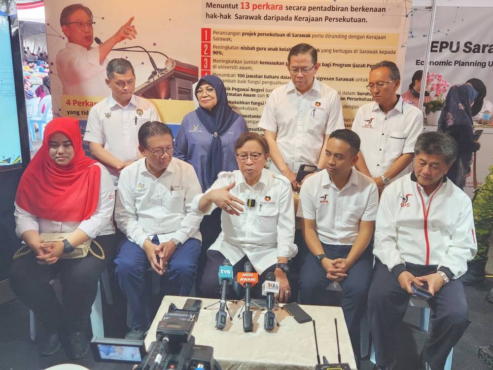Abang Johari addresses the press conference. On his right is Minister of Utility and Telecommunication Datuk Julaihi Narawi. — Borneo Post Online pic