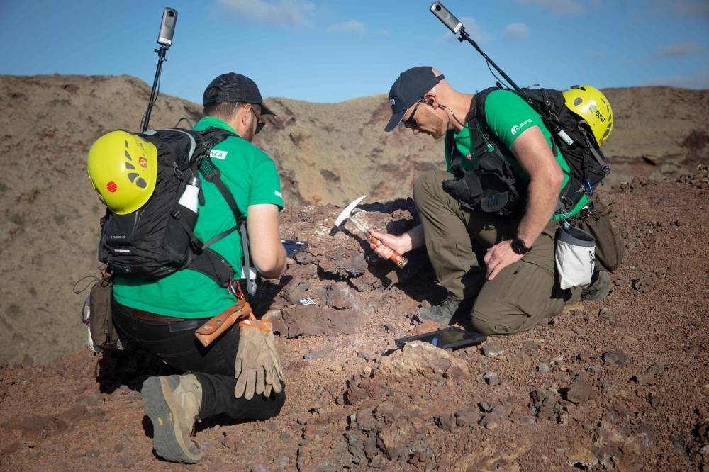 German astronaut Alexander Gerst (right) collects rock on the summit of an ancient volcano during a training program to learn how to explore the Moon and Mars in the Timanfaya National Park in the Canary island of Lanzarote on November 10, 2022. ― AFP pic