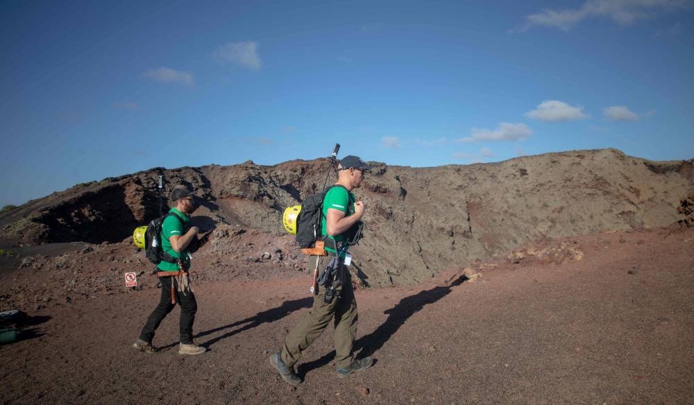German astronaut Alexander Gerst (right) collects rock on the summit of an ancient volcano during a training program to learn how to explore the Moon and Mars in the Timanfaya National Park in the Canary island of Lanzarote on November 10, 2022. ― AFP pic