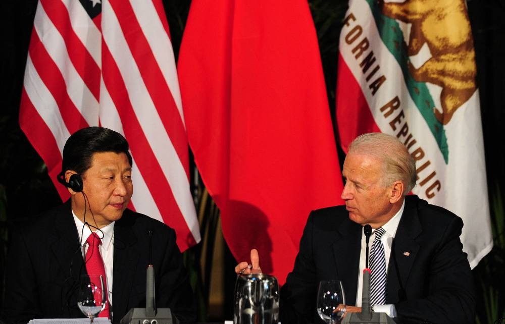 In this file photo taken on February 17, 2012 US Vice President Joe Biden (right) speaks as his visiting Chinese counterpart  Xi Jingping (left) looks on during a meeting of governors in Los Angeles, in California. ― AFP pic