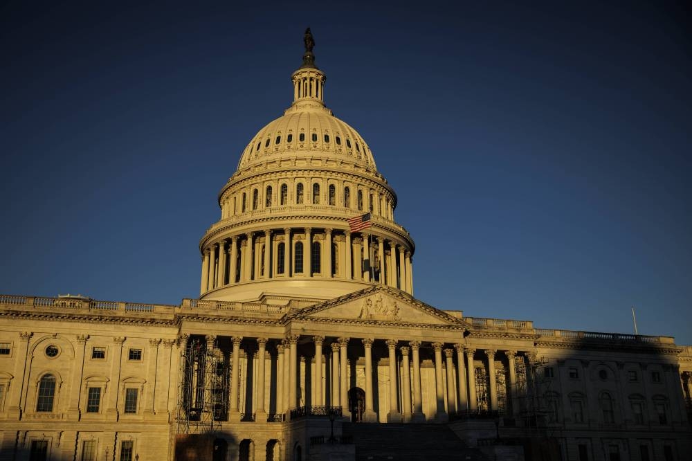 The rising sun creeps across the US Capitol building on November 9, 2022 in Washington, DC. Americans participated in the midterm elections to decide close races across the country after months of candidate campaigning. ― AFP pic