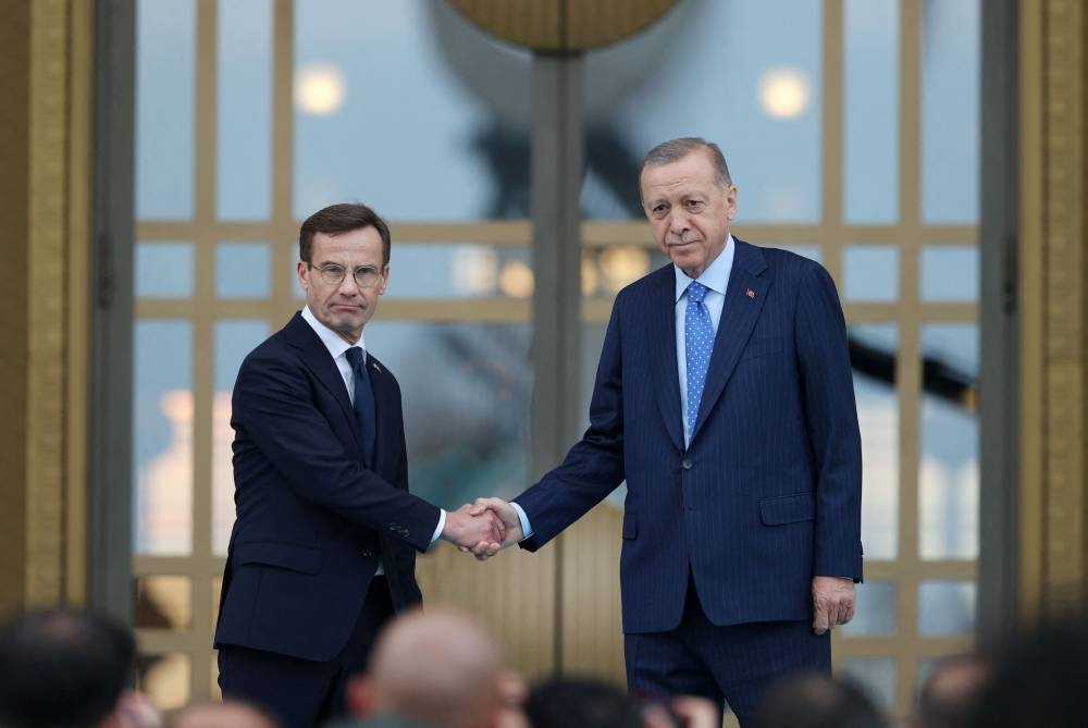 Turkish President Tayyip Erdogan and Swedish Prime Minister Ulf Kristersson pose after a welcome ceremony at the Presidential Palace in Ankara, Turkey, November 8, 2022. ― Reuters pic